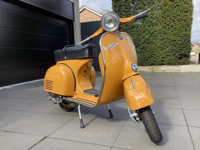 Oranje klassieke Vespa uit de jaren zestig